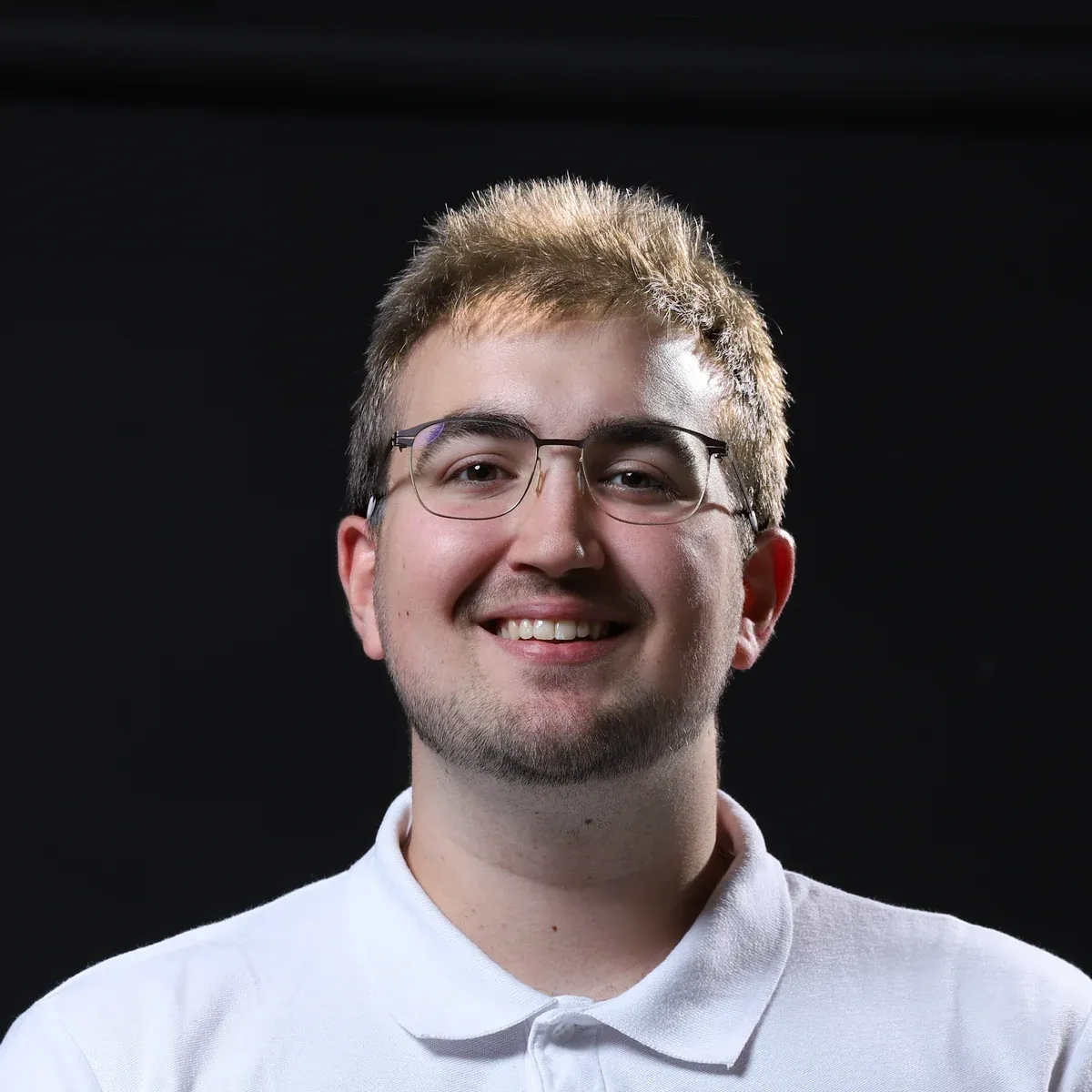 Marc Sanchis, in a white polo, smiling.